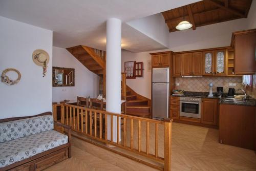a kitchen with wooden cabinets and a staircase in a house at Villa Aelia in Alonnisos