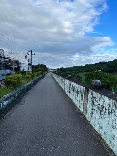 an empty road next to a concrete wall at 幸福來了-近花蓮火車站 寵物友善 電梯民宿 in Hualien City