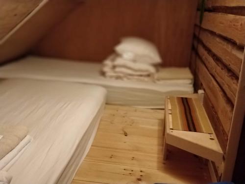 a small room with two beds and a wooden floor at Uneallika peamaja in Pae