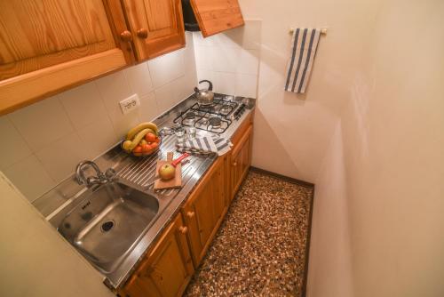 a small kitchen with a sink and a stove at Palazzetto San Lio, Rialto in Venice
