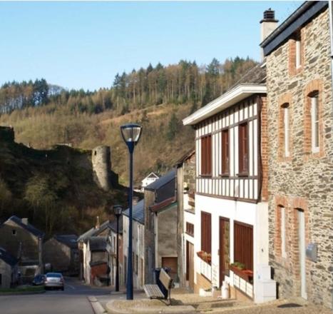 a street with a stone building and a street light at Le repaire des amoureux in La Roche-en-Ardenne