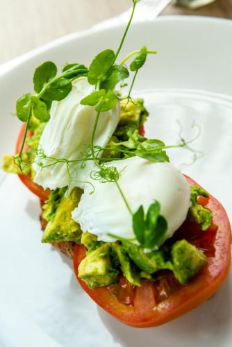 a tomato with a poached egg and broccoli on a plate at The Porlock Weir Hotel in Porlock