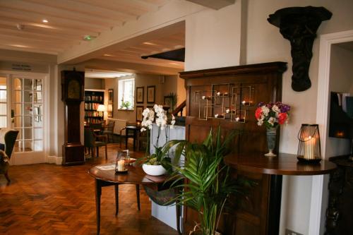 a living room with a table and flowers on it at The Porlock Weir Hotel in Porlock
