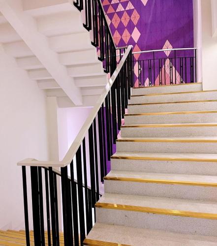 a set of stairs with a mural on the wall at Centara Life Hotel Bangkok Phra Nakhon in Bangkok