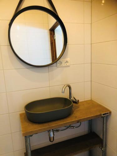 a bathroom with a black sink and a mirror at B &B Yuupke Maasbree Noord-Limburg Venlo Roermond in Maasbree