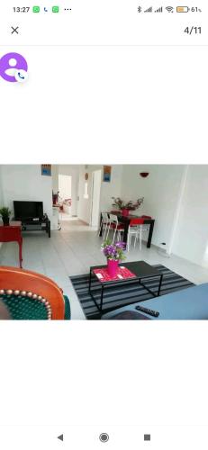 a living room with a table and chairs at Logement tout confort Vernet les Bains à côté des thermes in Vernet-les-Bains