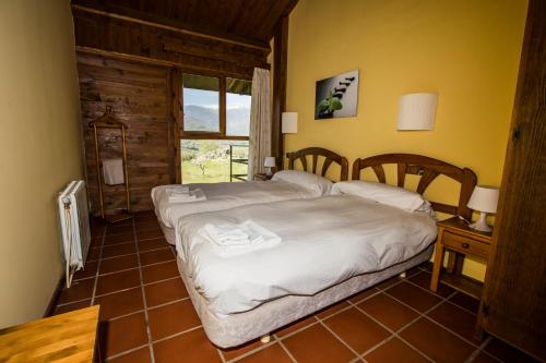 a bedroom with a bed in a room with a window at La Hospedería Del Silencio in Robledillo de la Vera