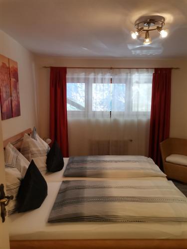 a bedroom with a large bed with a window at Ferienwohnung Hohe Wand in Heiligenblut