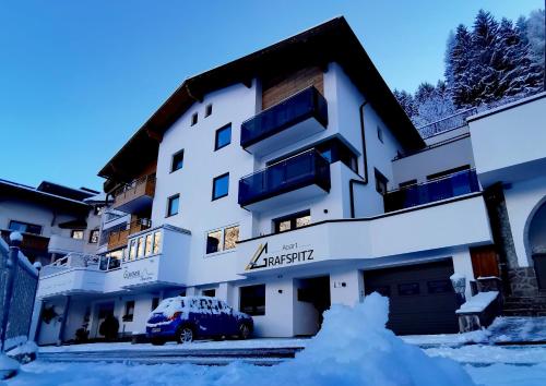 a building with a car parked in front of it at Apart Grafspitz in Ischgl