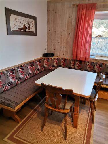 a couch with a table and a bench at Ferienwohnung Hohe Wand in Heiligenblut