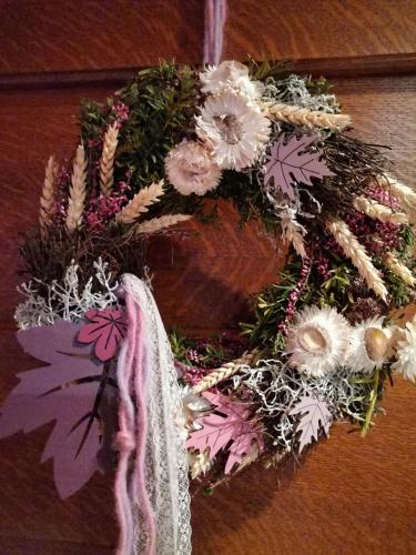 a wreath of flowers is hanging on a wall at Ferienwohnung Hohe Wand in Heiligenblut