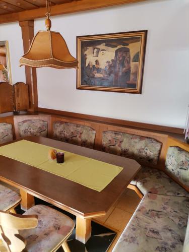 a dining room with a table and a picture on the wall at Ferienwohnung Hohe Wand in Heiligenblut
