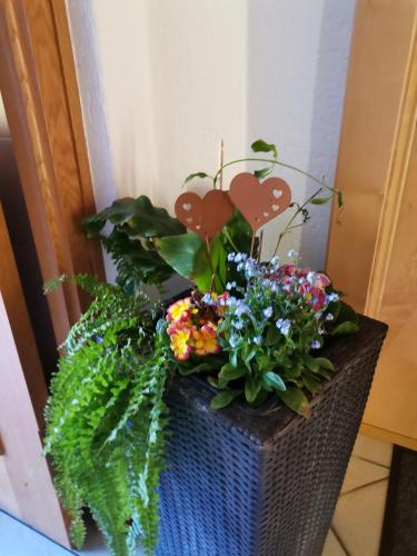 a basket with flowers and hearts on it at Ferienwohnung Hohe Wand in Heiligenblut