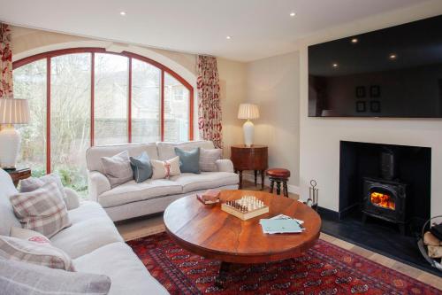 a living room with a couch and a table at Lucknam Park Hotel in Chippenham
