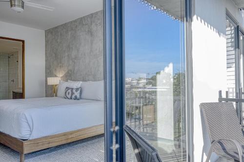 a bedroom with a bed and a large window at Urban Tower A211 in Playa del Carmen