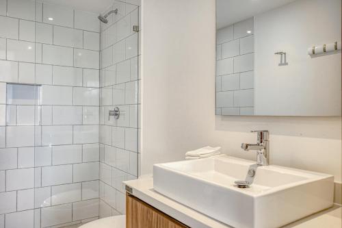 a white bathroom with a sink and a shower at Urban Tower A211 in Playa del Carmen