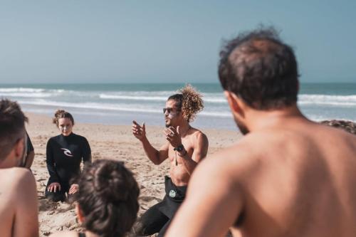 a group of people sitting on the beach at Wavy Days in Tamraght Ouzdar