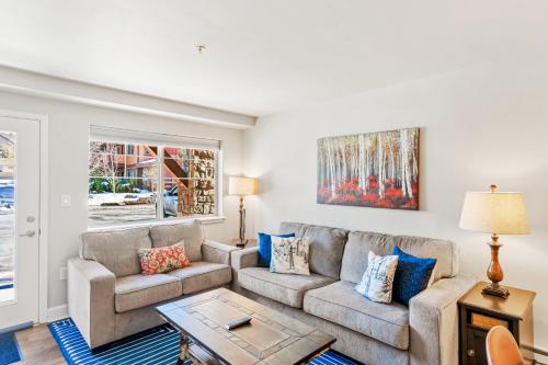 a living room with a couch and a table at First Tracks 4105 in Steamboat Springs