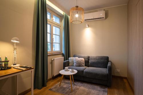 a living room with a couch and a table at Villa Bałtycka in Gdańsk