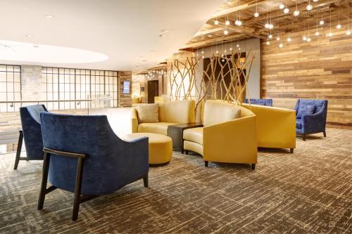 a waiting room with yellow and blue chairs at Archer Hotel Napa in Napa