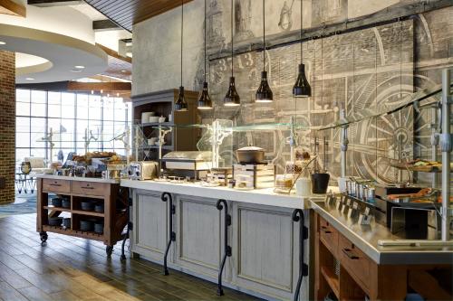 a kitchen with a large counter in a room at Archer Hotel Boston/Burlington in Burlington
