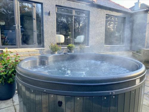 a large hot tub in front of a house at Festival Villa and City Villa in Edinburgh