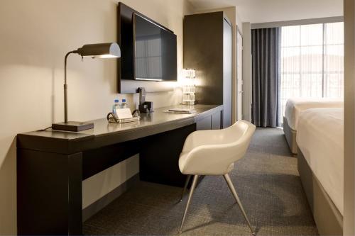 a hotel room with a desk and a bed at Archer Hotel Boston/Burlington in Burlington