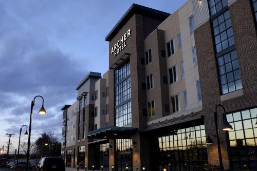 a large building with windows on a city street at Archer Hotel Boston/Burlington in Burlington
