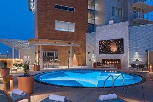 an image of a pool in front of a building at Archer Hotel Austin in Austin