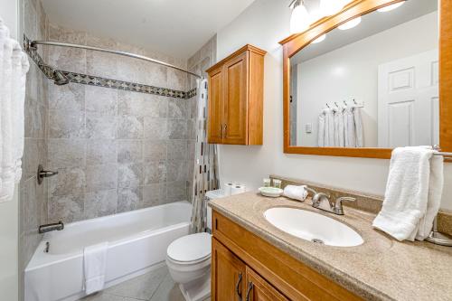 a bathroom with a sink and a tub and a toilet at Take Me to Tahoe in Incline Village