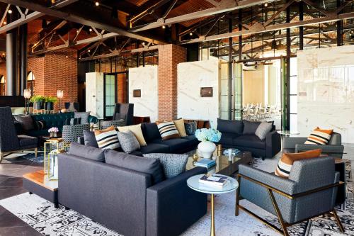 a living room with couches and chairs in a building at Archer Hotel Tysons in Tysons Corner