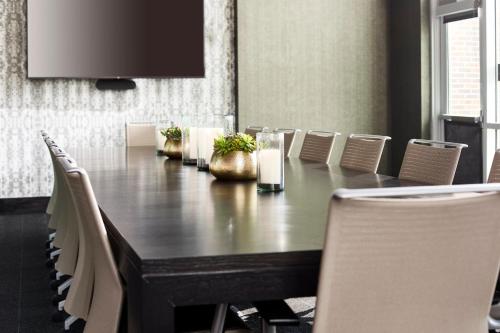 a conference room with a wooden table and chairs at Archer Hotel Tysons in Tysons Corner