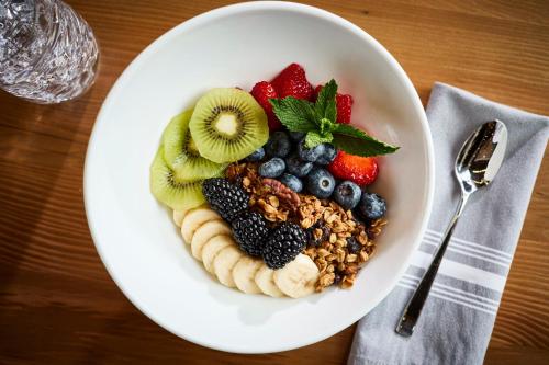 a bowl of fruit and nuts on a table at Archer Hotel Tysons in Tysons Corner