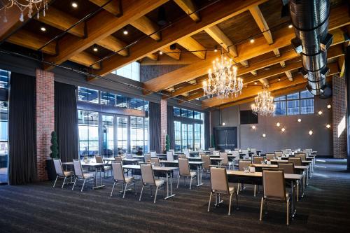 a banquet hall with tables and chairs in a room with windows at Archer Hotel Tysons in Tysons Corner