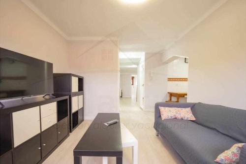 a living room with a couch and a table at El Pico, Apartamento in Ribadesella