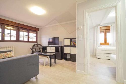 a living room with a couch and a table at El Pico, Apartamento in Ribadesella