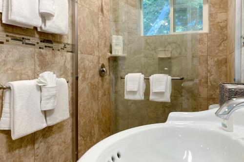 a bathroom with a sink and a shower with towels at Balboa Bliss in McKinleyville