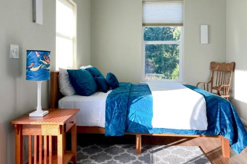 a bedroom with a bed and a window at Balboa Bliss in McKinleyville