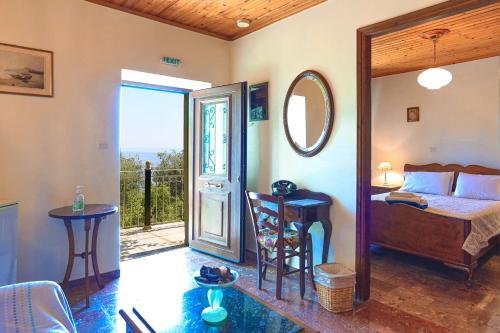 a bedroom with a bed and a table and a mirror at Old Stone House in Nisaki