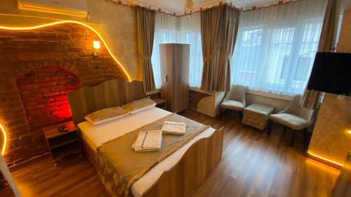 a hotel room with a bed and a fireplace at GOLDEN ARROW OLD CİTY HOTEL in Istanbul