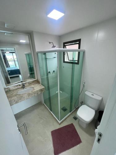 a bathroom with a glass shower and a toilet at Nascer do sol 102 in Arraial do Cabo