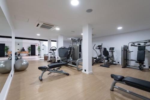 a gym with several treadmills and exercise bikes at Occidental Roca Negra - Adults Only in Agaete