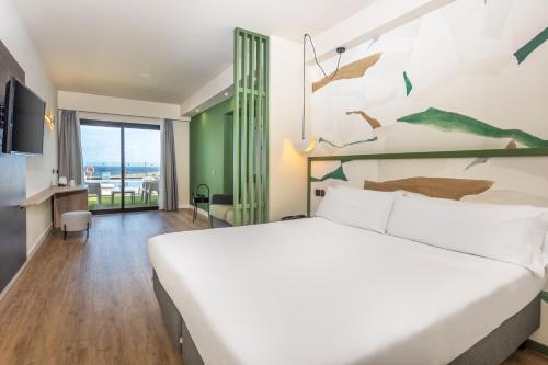 a bedroom with a large bed and a wall with birds on it at Occidental Roca Negra - Adults Only in Agaete