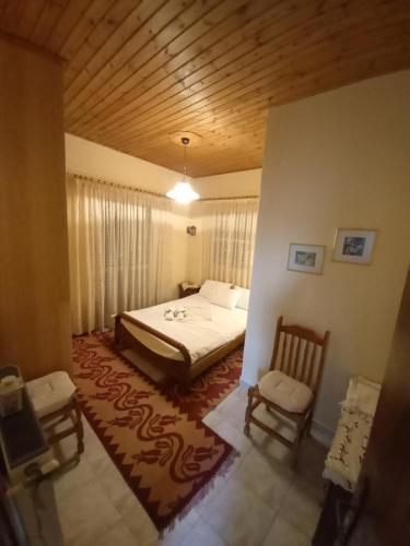 a bedroom with a bed and two chairs in it at Phaedra Electra Estate in Tsoukalaíika
