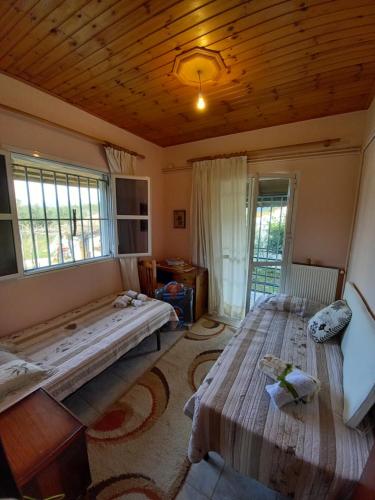 1 dormitorio con 2 camas y techo de madera en Phaedra Electra Estate 