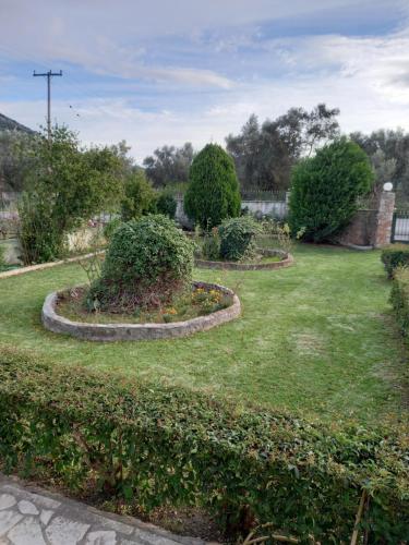 a garden with three circular hedges and bushes at Phaedra Electra Estate in Tsoukalaíika