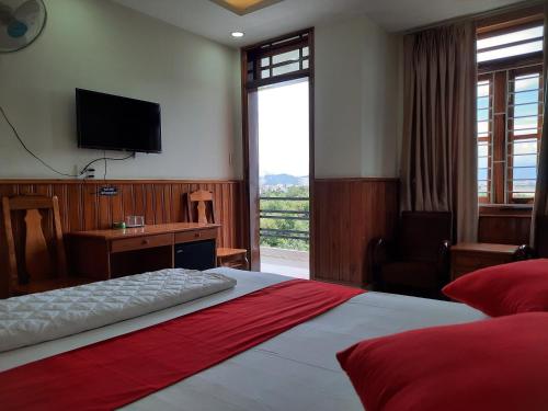 a bedroom with a large bed with a television on the wall at Thien Truong Hotel in Nha Trang