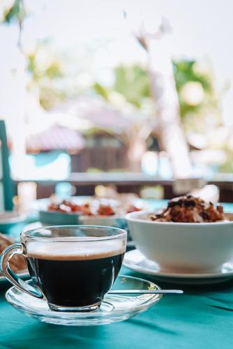 two cups of coffee and a bowl of food on a table at Baan Kiao in Haad Yao