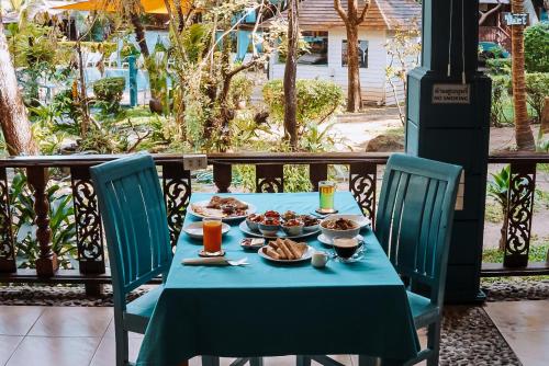 a table with a blue table cloth and food on it at Baan Kiao in Haad Yao