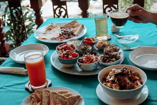 a blue table topped with plates of food and drinks at Baan Kiao in Haad Yao
